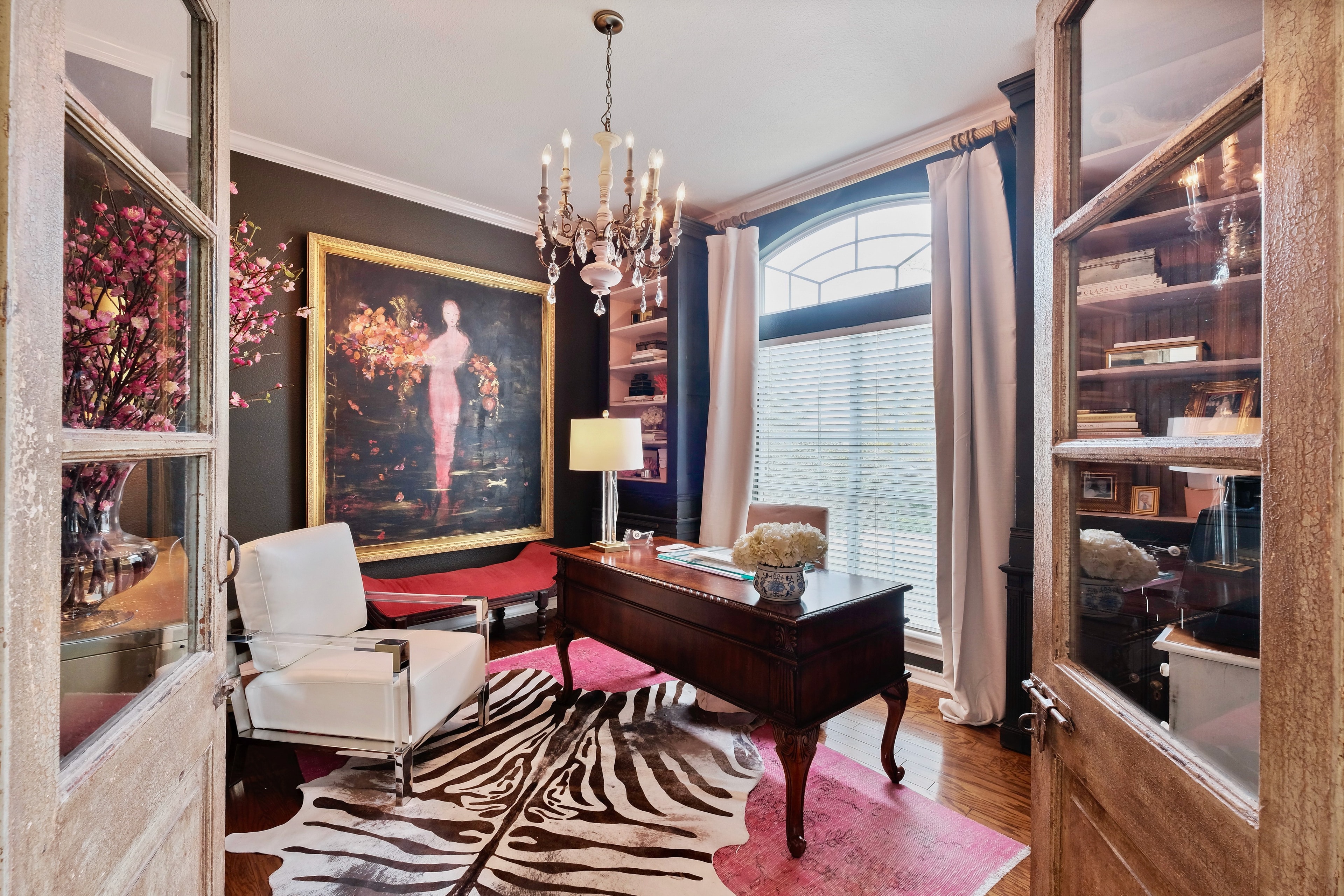 Elegantly designed home office with chandelier and statement artwork