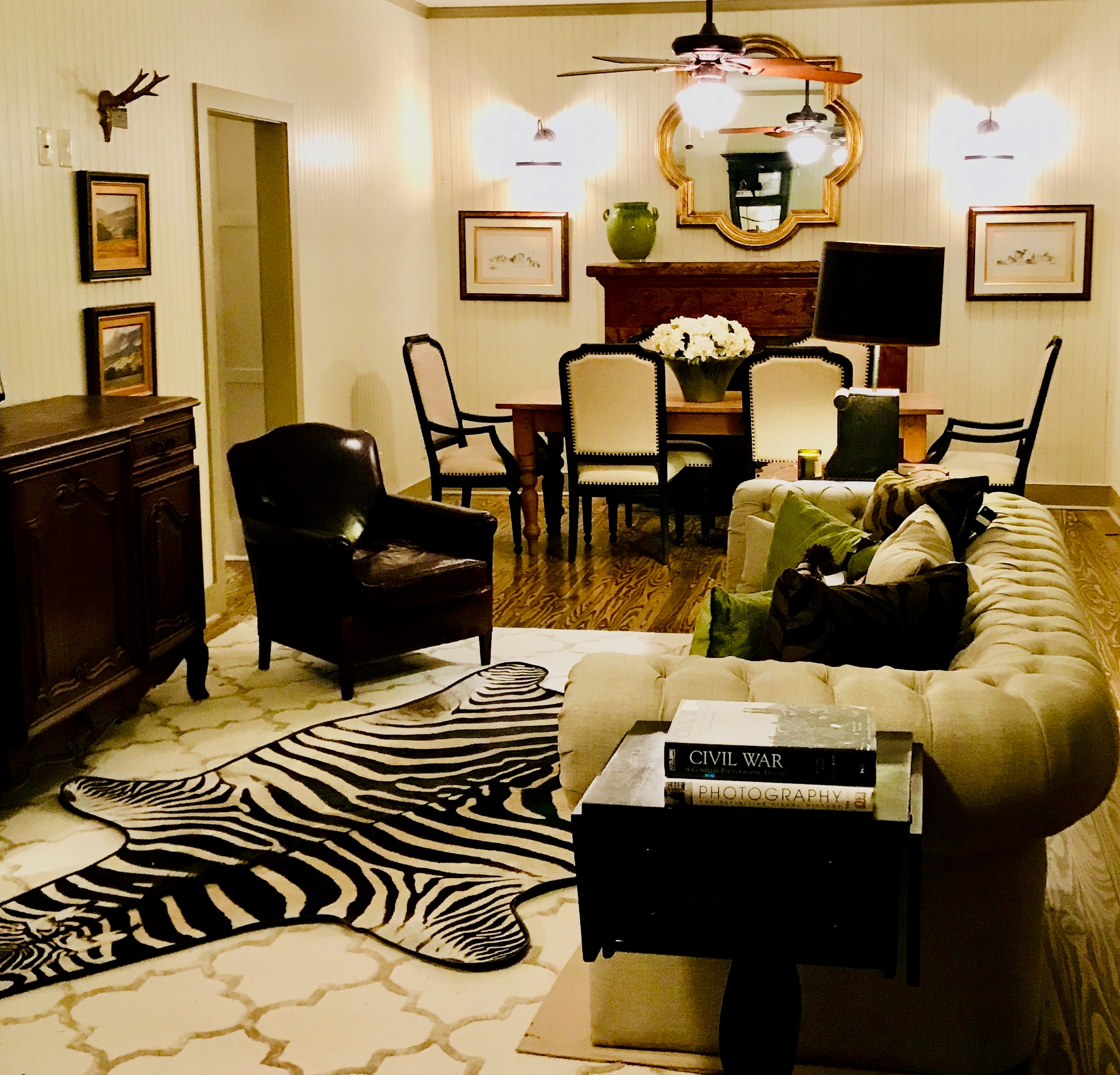 Classic living room with zebra rug and tufted sofa