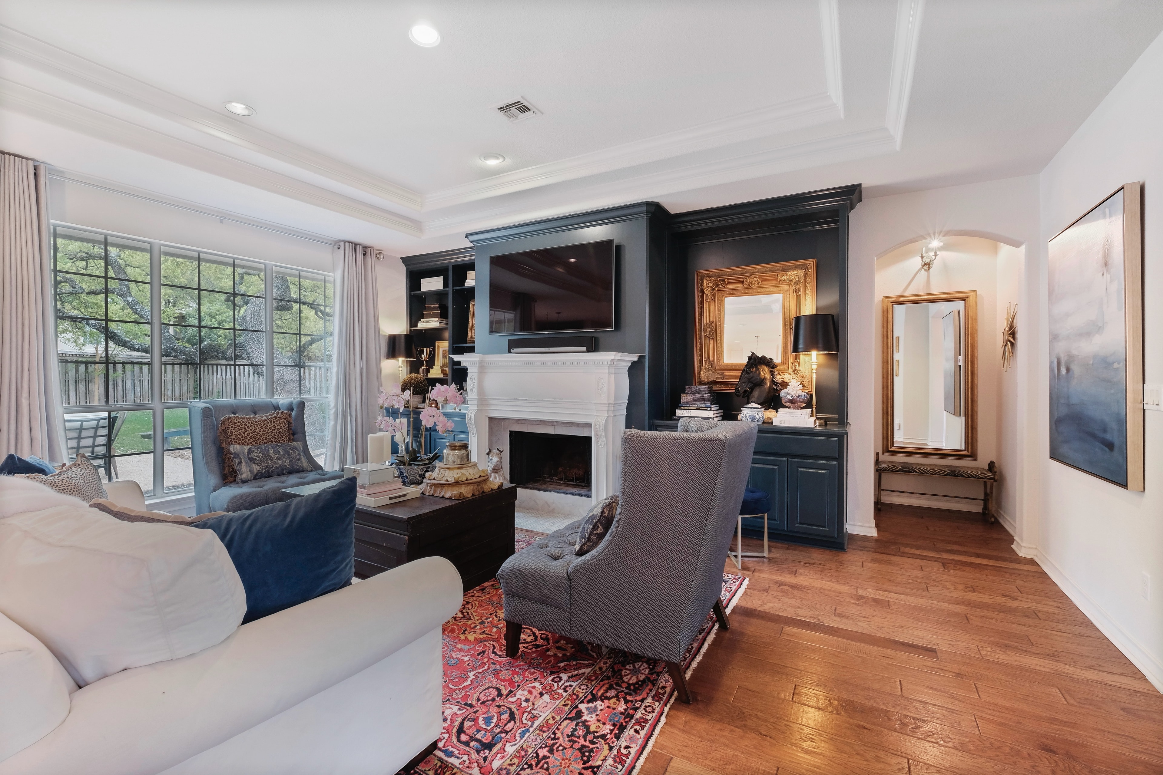 Elegant living room with navy built-ins and Persian rug